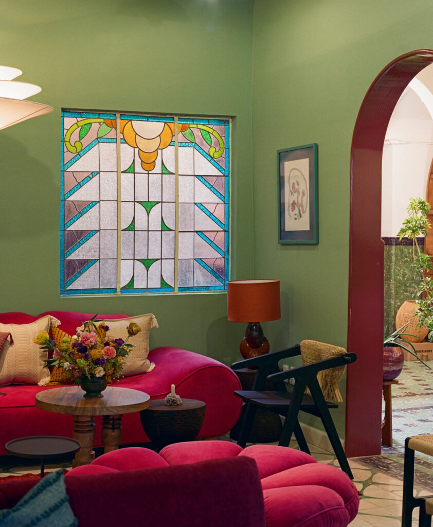 hotel san fernando hotel interior decorated with contrasting colours green and pink, featuring the building's original stained glass windows